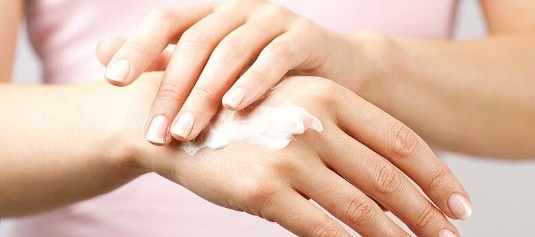 application of cream on the skin of the hands