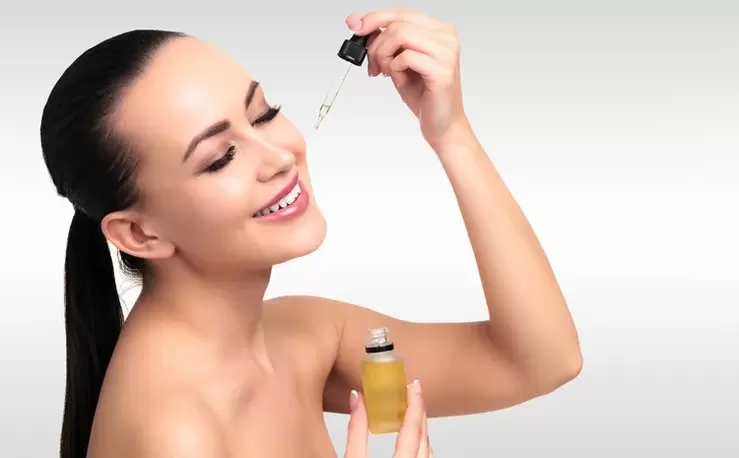 woman applying serum on face